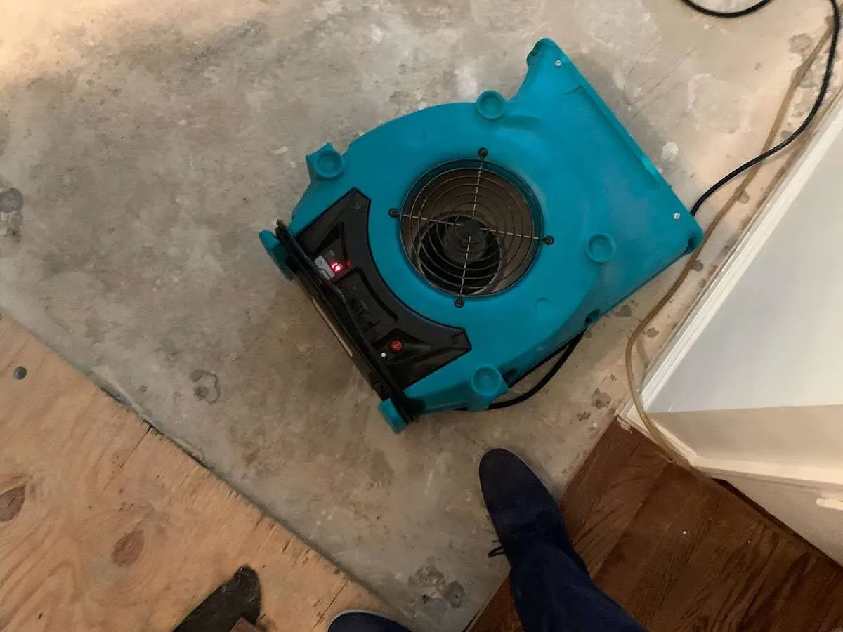 Air mover drying subfloor during Commercial Water Damage Restoration in La Porte